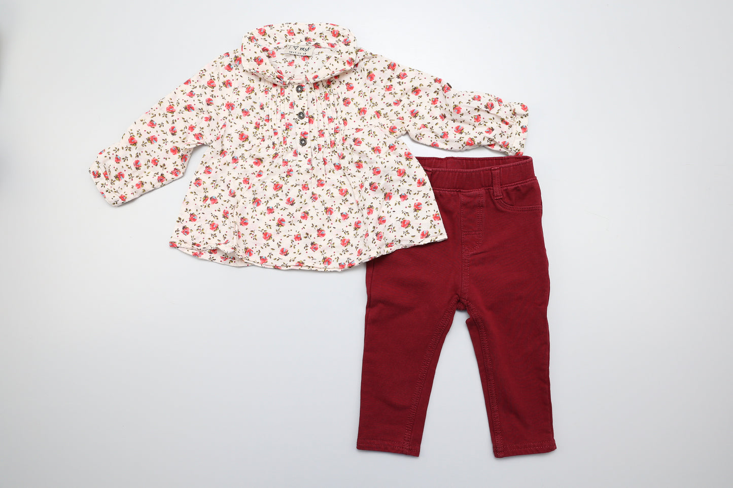 Mädchen Set in Bordeaux mit Blumenbluse. Die Bluse ist von Next und hat vorne 3 Knöpfe, die Ärmel können hochgekrempelt und geknöpft werden. Die Leggings ist von H&M und hat hinten zwei Taschen. 74