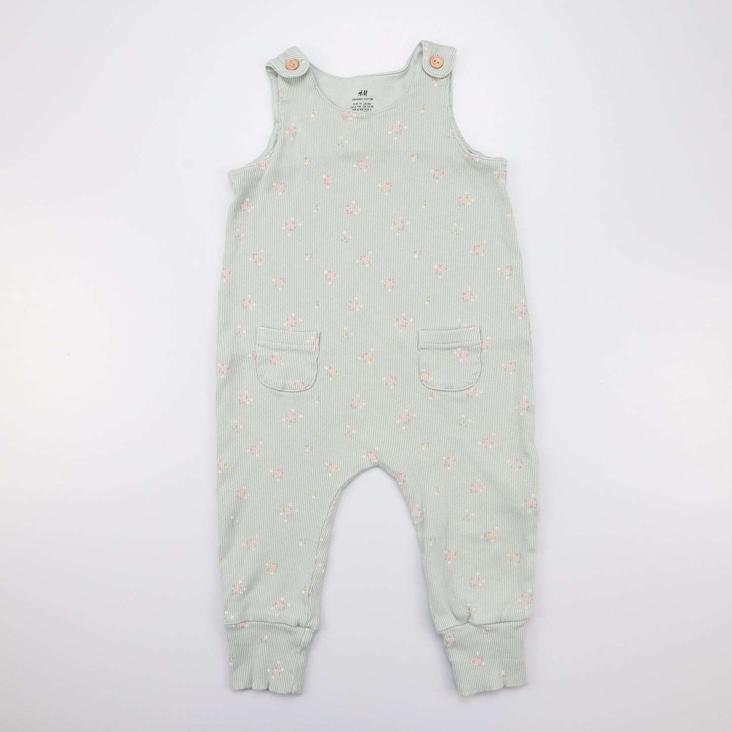 hellgrüne Latzhose mit kleinen Blumenmuster und Knöpfen oben