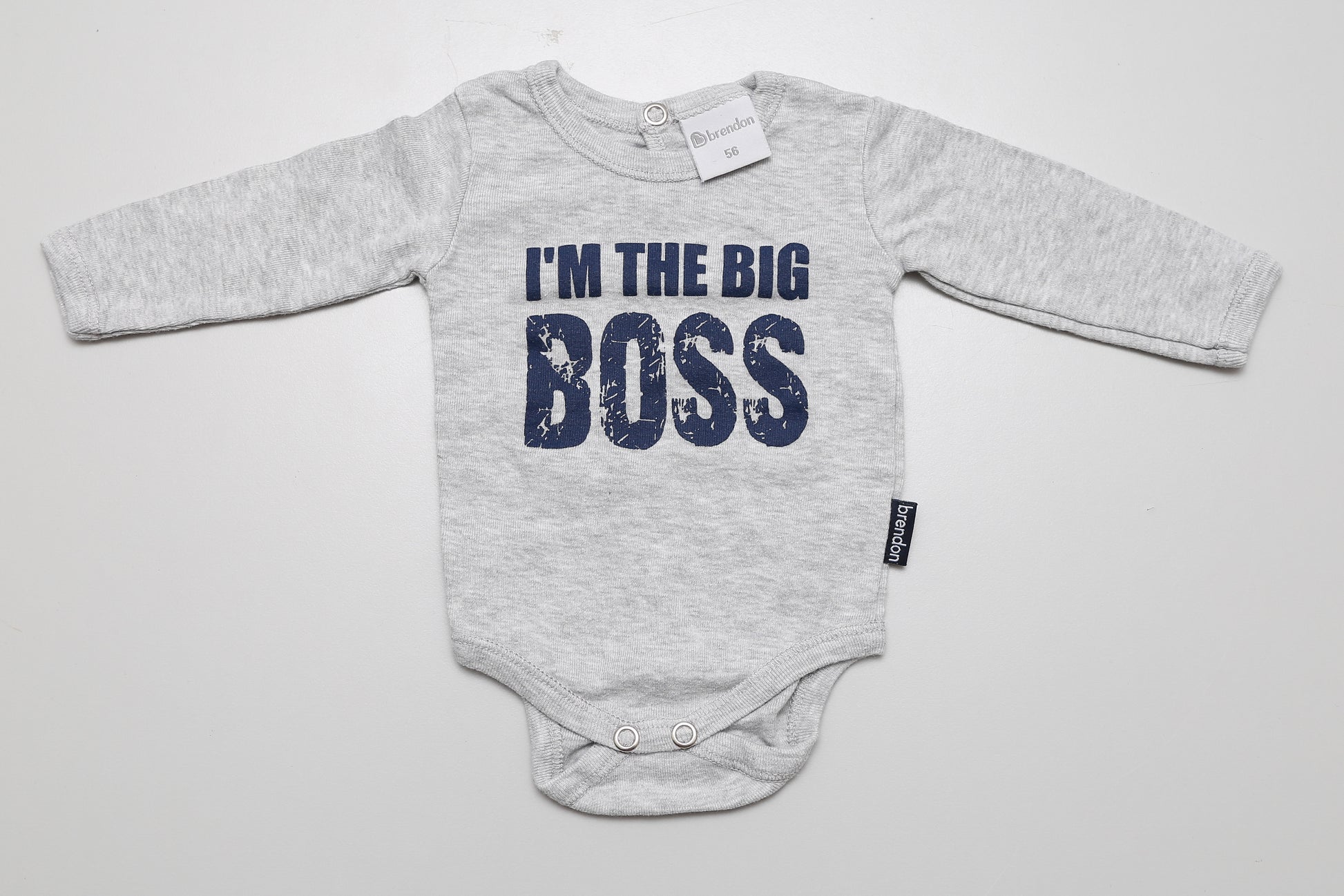 Grauer Langarm-Body aus Baumwolle mit „I’m the big boss“-Aufschrift. Hinten mit Druckknopf. Größe 56.